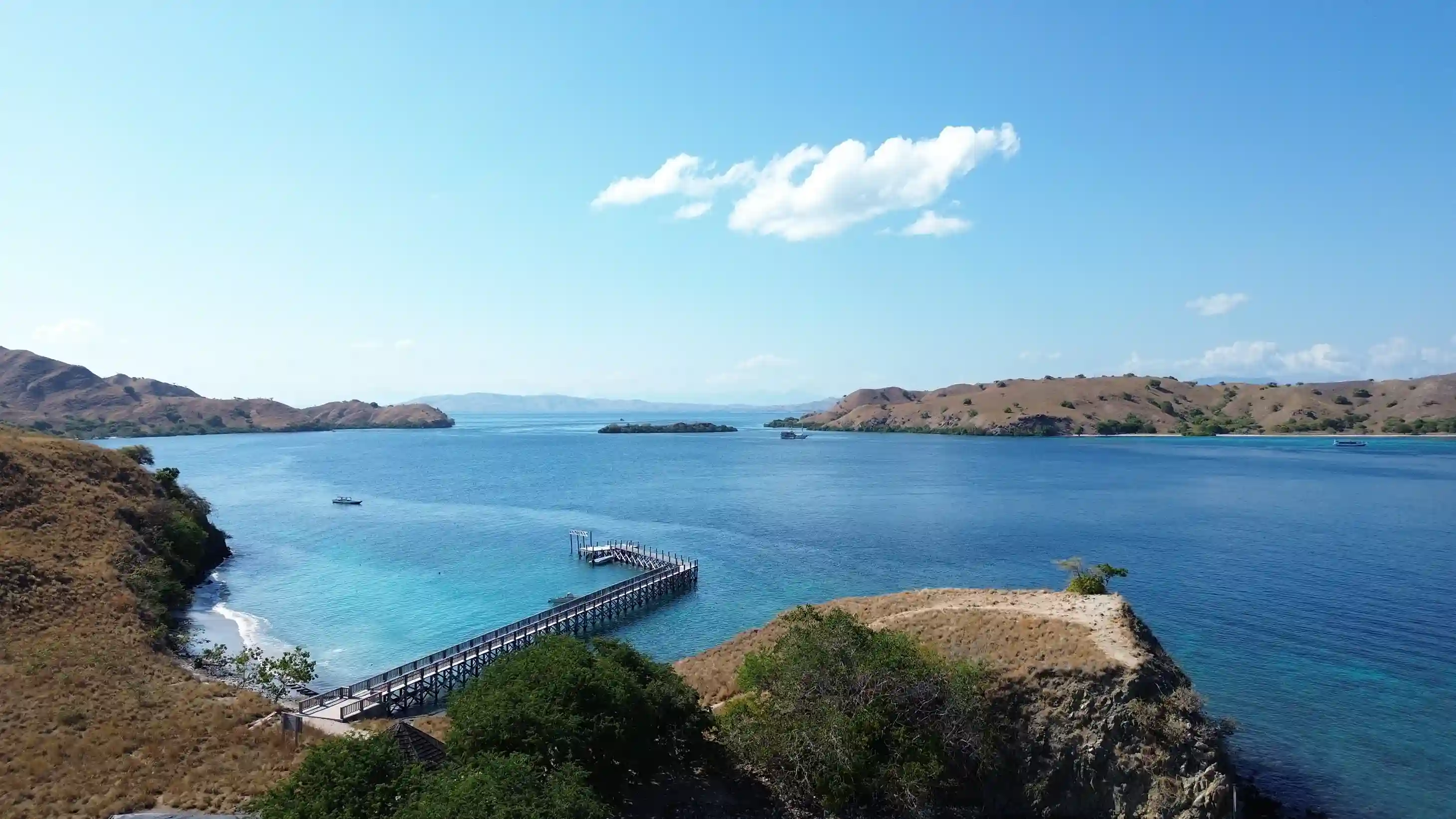 Aerial view of a Gili island jetty reaching into turquoise water