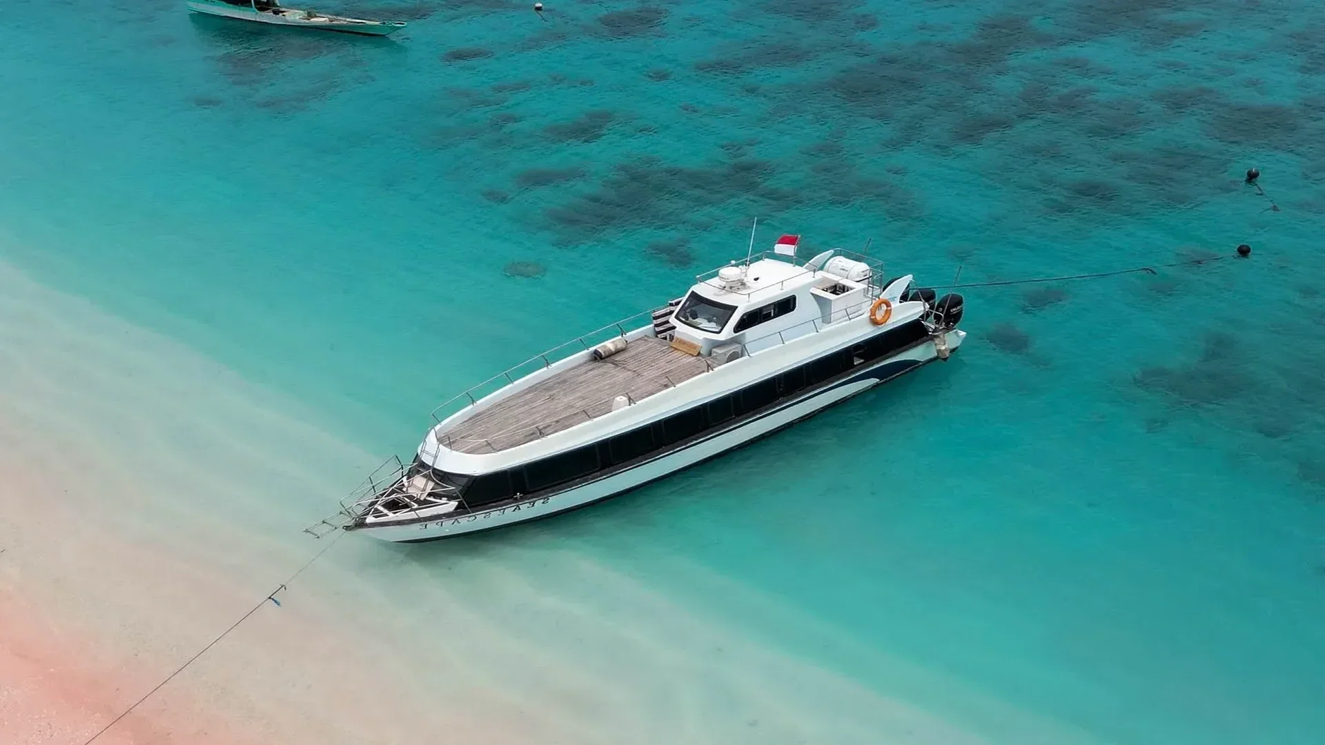Speedboat crossing pale turquoise shallows
