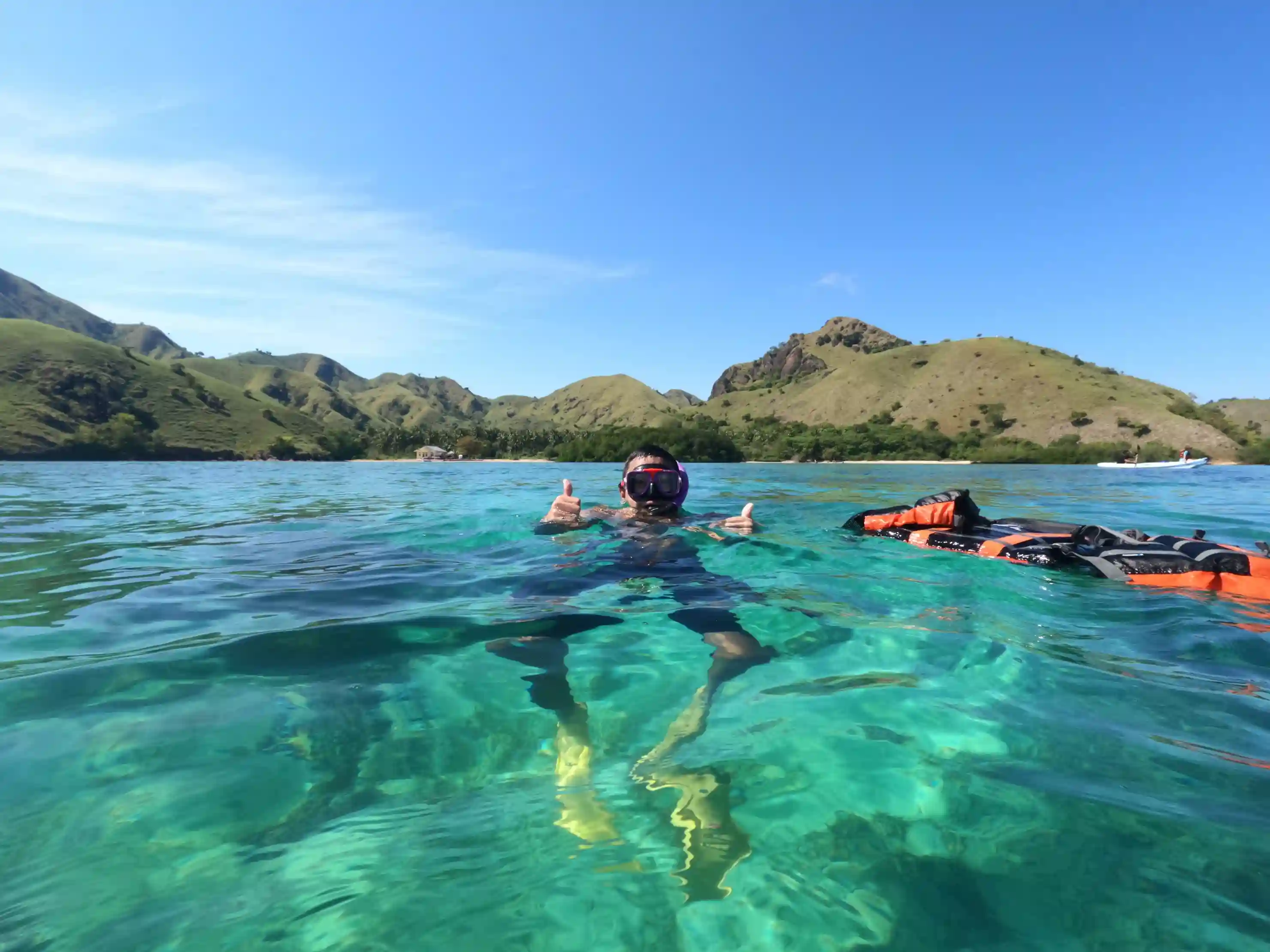 Snorkellers floating in clear shallow water near the islands